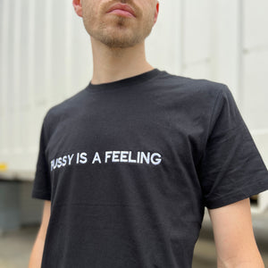 PUSSY IS A FEELING BLACK T-SHIRT WITH EMBROIDERED SIGN