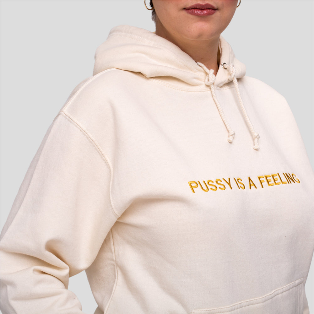 Vanilla hoodie with golden PUSSY IS A FEELING embroidery designed by Identities Brand.