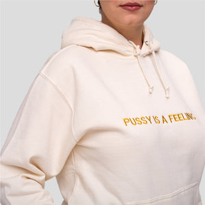 Vanilla hoodie with golden PUSSY IS A FEELING embroidery designed by Identities Brand.