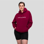 Burgundy hoodie with white PUSSY IS A FEELING embroidery designed by Identities Brand.