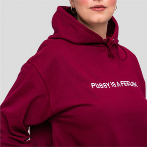 Burgundy hoodie with white PUSSY IS A FEELING embroidery designed by Identities Brand.